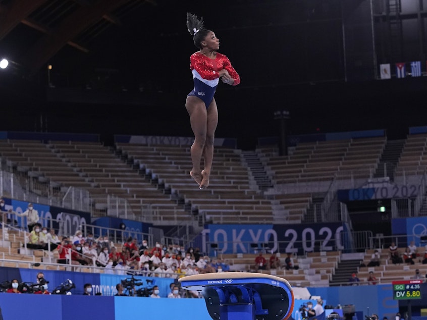 caption: Simone Biles from the U.S. performs on the vault during the gymnastics women's team final at the Summer Olympics on Tuesday in Tokyo.