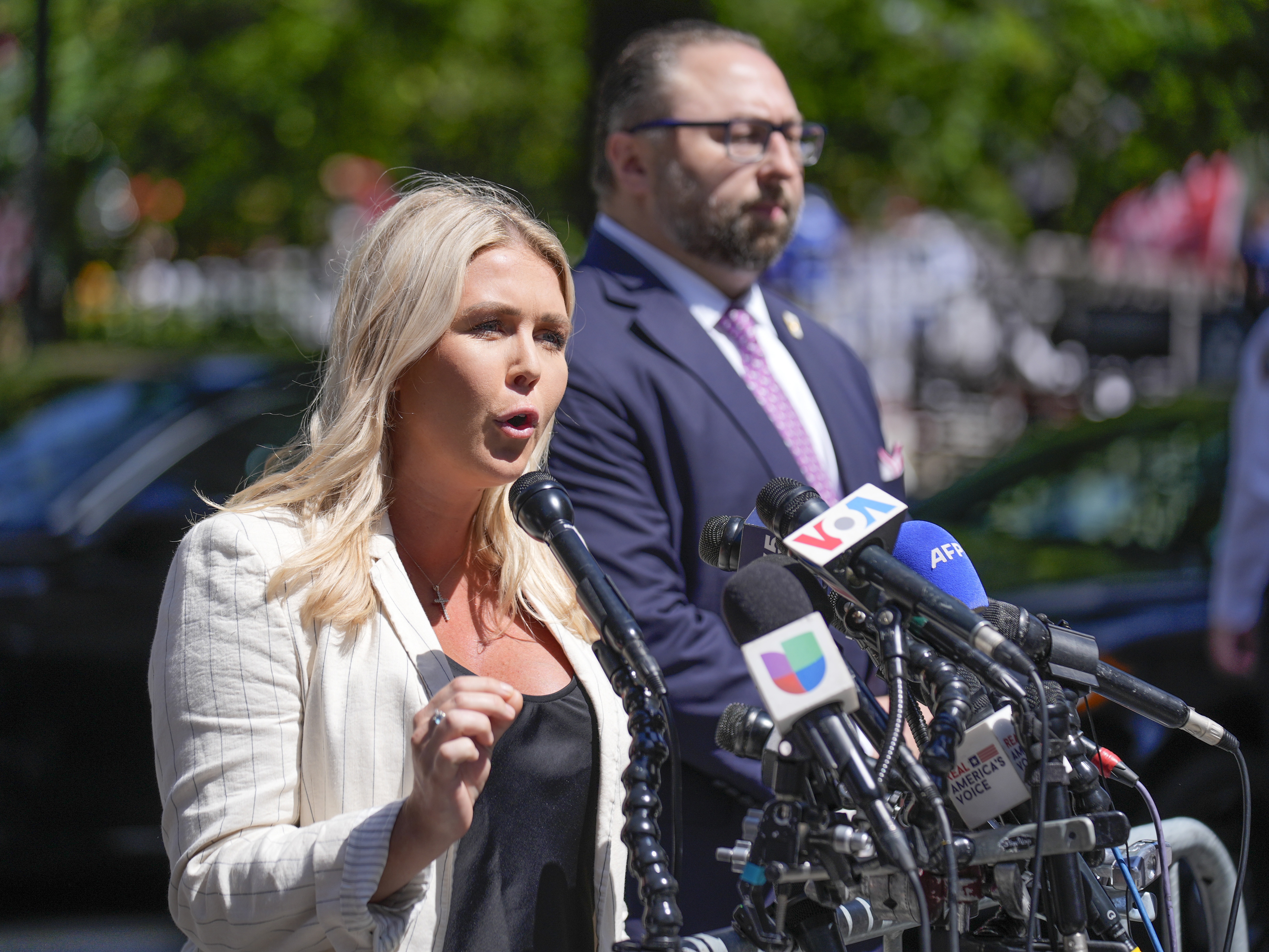 caption: Karoline Leavitt, former President Donald Trump's campaign press secretary, speaks to reporters across the street from Trump's criminal trial in New York on May 28. Leavitt will be the youngest person to ever hold the job of top White House spokesperson.