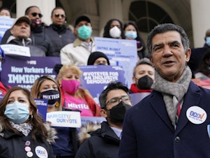 caption: New York City Councilor Ydanis Rodriguez speaks during a rally Thursday on the steps of City Hall ahead of a council vote to allow lawful permanent residents to cast votes in elections to pick the mayor, city councilors and other municipal officeholders.