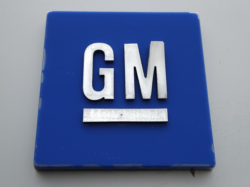 caption: The General Motors logo is displayed outside the General Motors Detroit-Hamtramck Assembly plant, Jan. 27, 2020, in Hamtramck, Mich.