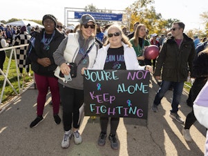 caption: Participants walk in support and in memory of those lost, during American Foundation for Suicide Prevention Out of the Darkness Chicagoland Walk at Montrose Harbor on October 21, 2023 in Chicago, Illinois.