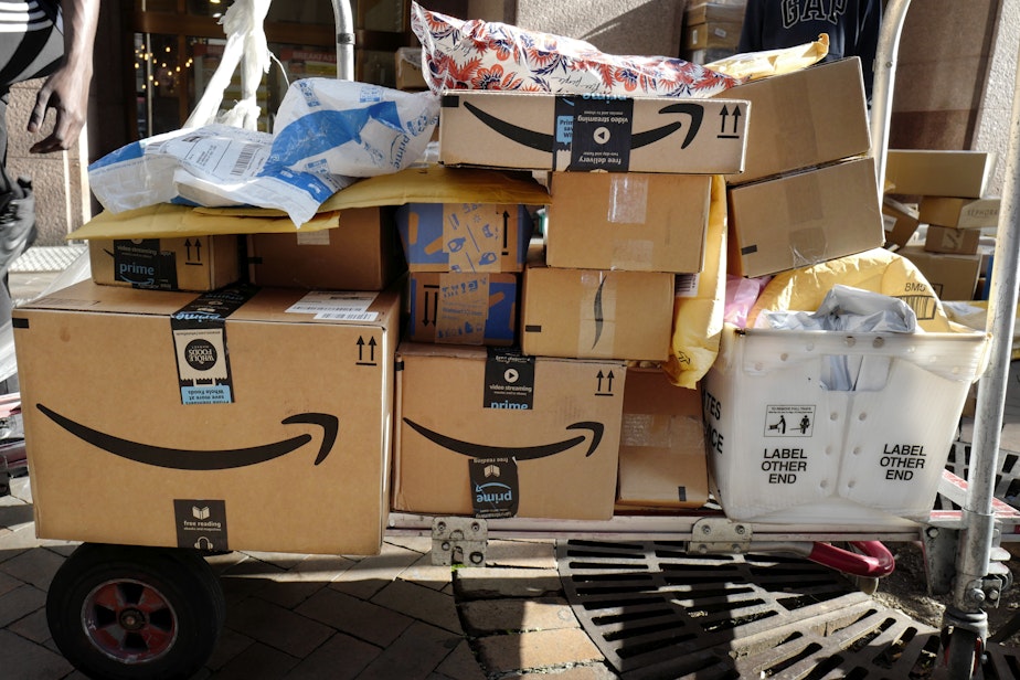 caption: Amazon Prime packages are loaded on a cart for delivery in New York. 