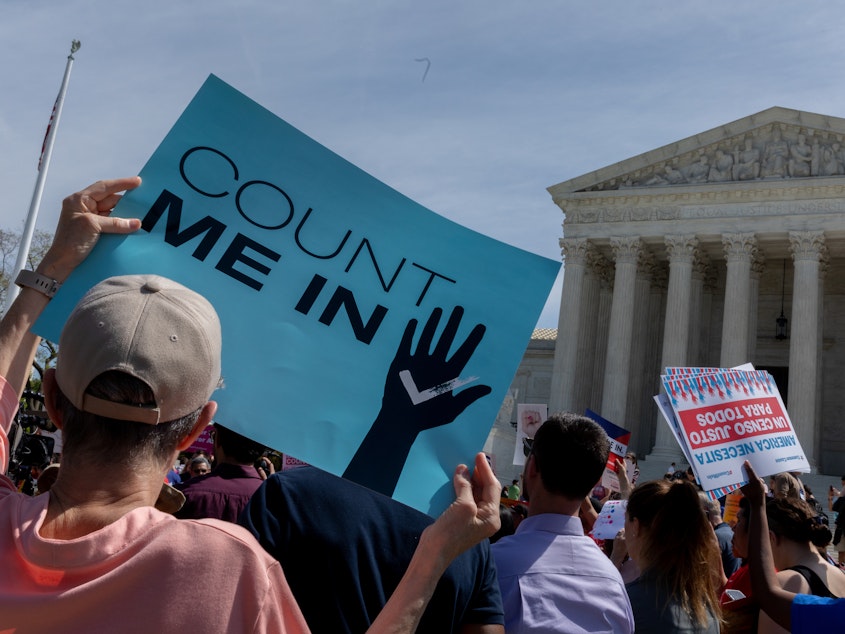caption: Protesters holding signs about the 2020 census gather outside the Supreme Court in Washington, D.C., in 2019.