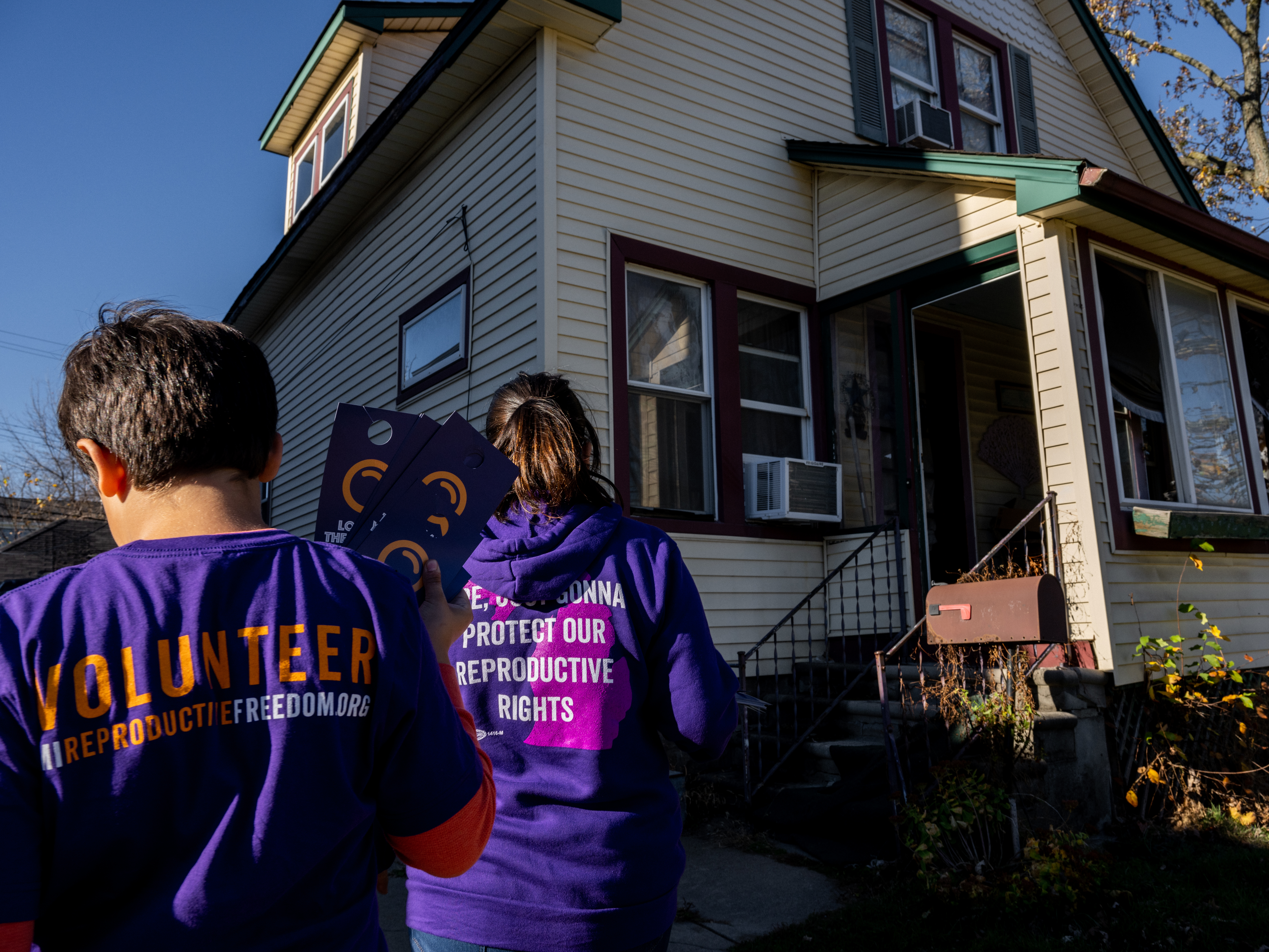 caption: Sandra Bucciero and her son Luke canvass for Proposal 3 last weekend in Dearborn, Mich. Voters approved the amendment protecting abortion rights.