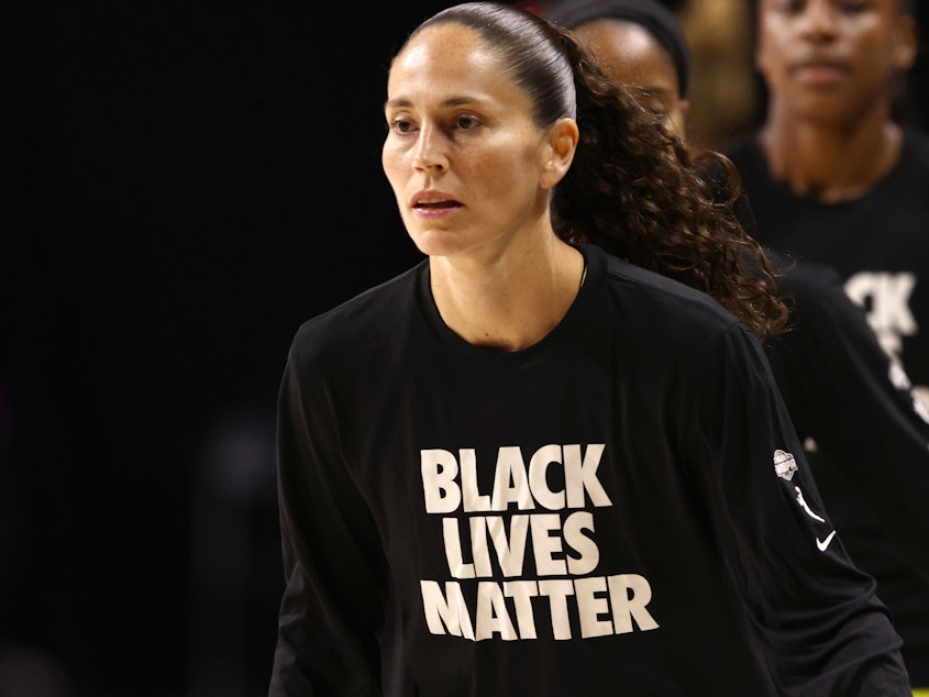 caption: Sue Bird of the Seattle Storm, wears "Black Lives Matter" warm-up shirts before a game in July.