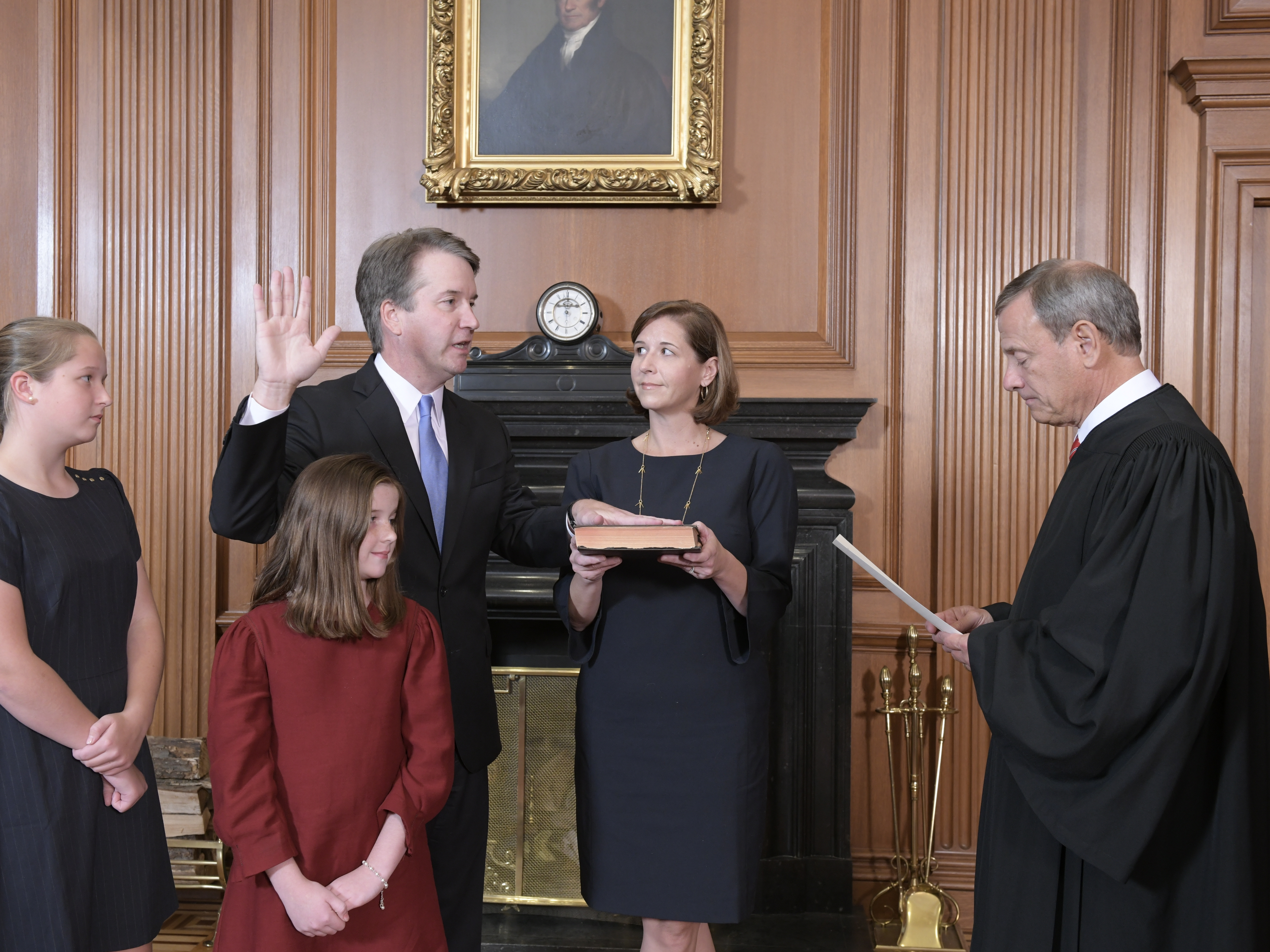 caption: Chief Justice John Roberts administers the constitutional oath to Judge Brett M. Kavanaugh as his wife, Ashley Kavanaugh, holds the Bible. They're accompanied by their daughters, Margaret and Liza.