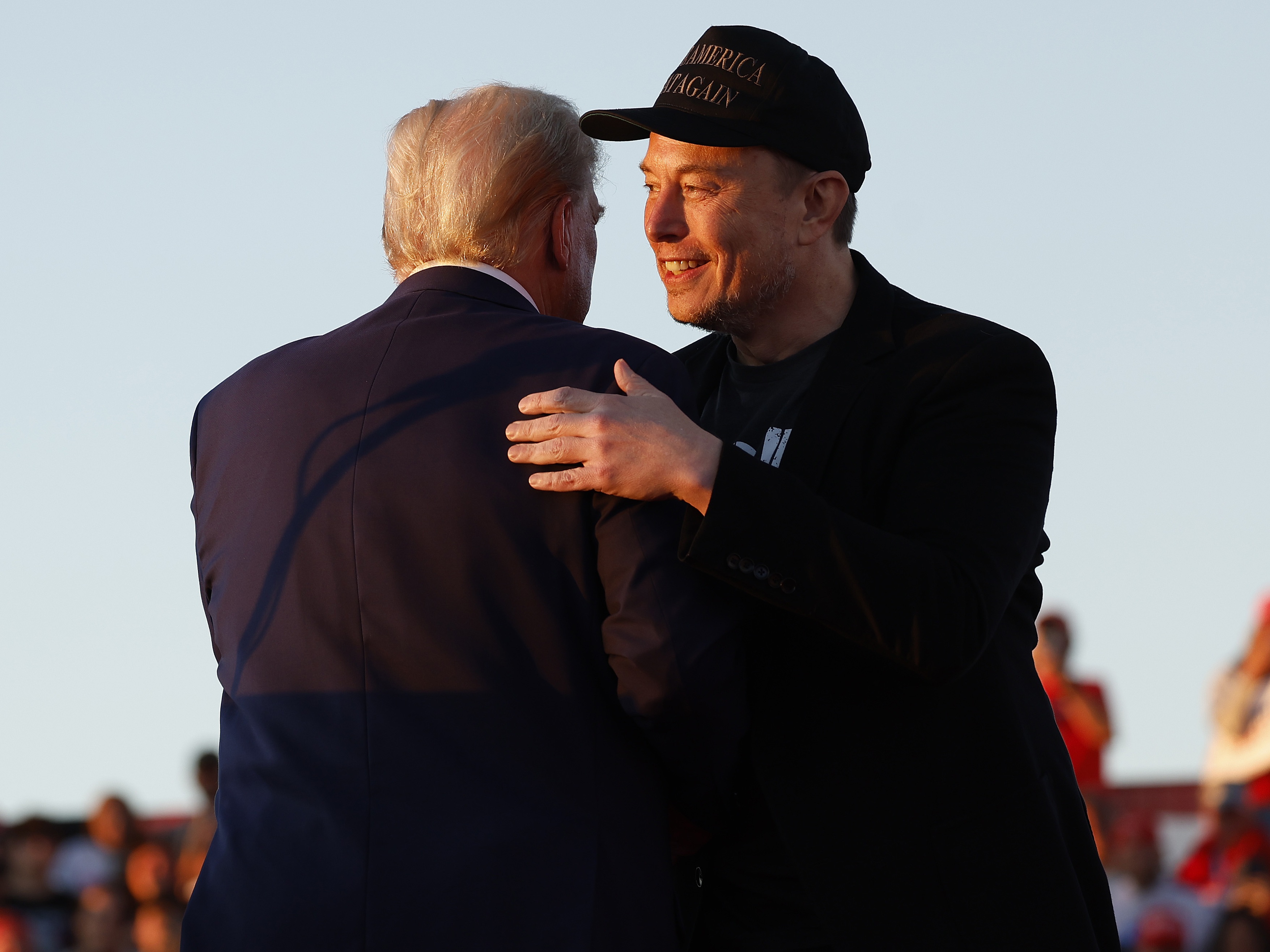 caption: President-elect Donald Trump embraces Elon Musk during an October campaign rally in Butler, Pennsylvania. Over the last few months, the two men have cultivated a warm relationship.