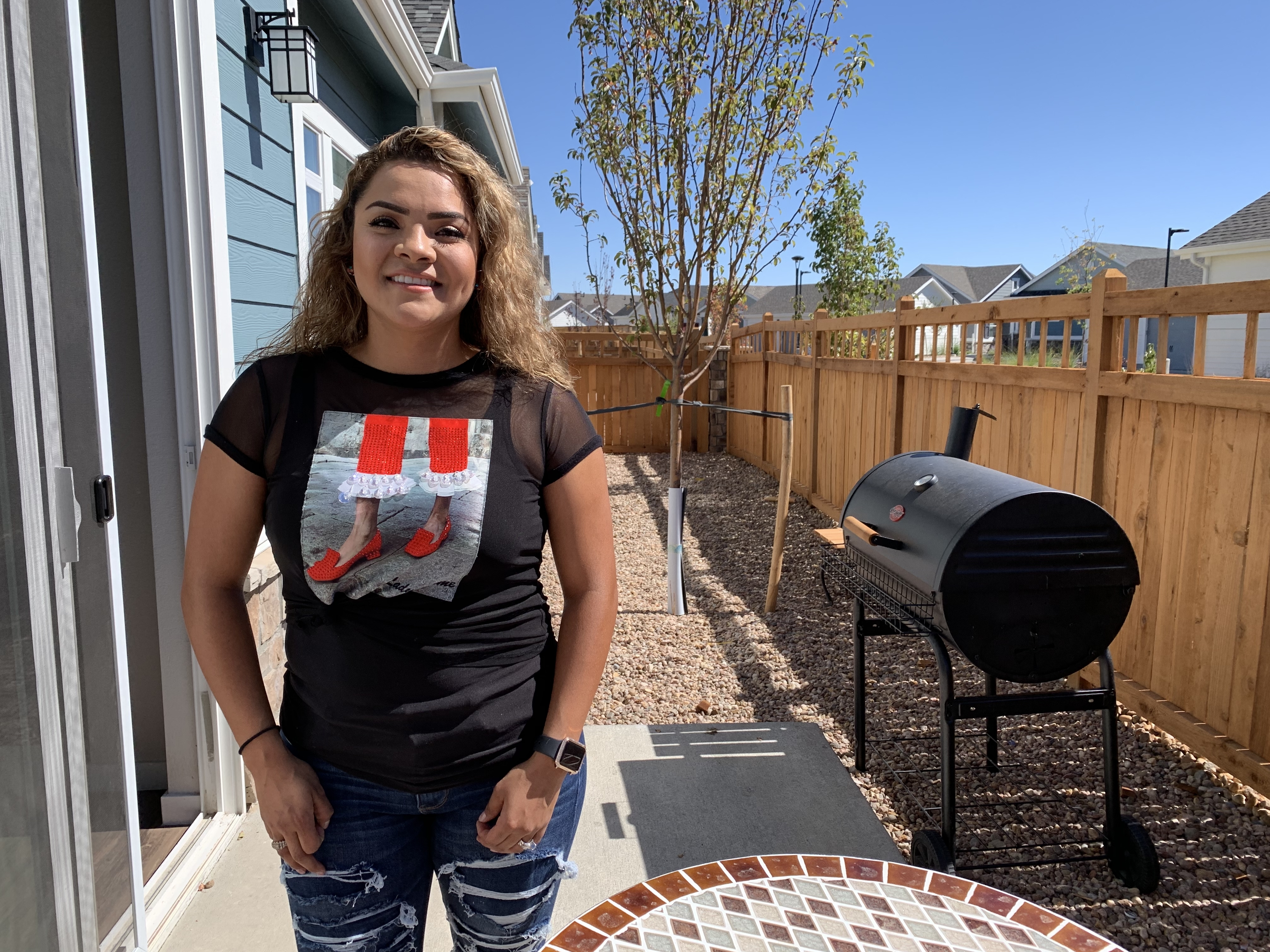caption: Itzel Alarcon recently moved in to a rental development near Denver. She says she's renting for now because she saw relatives hurt by the housing crash and is worried that home values might drop again.