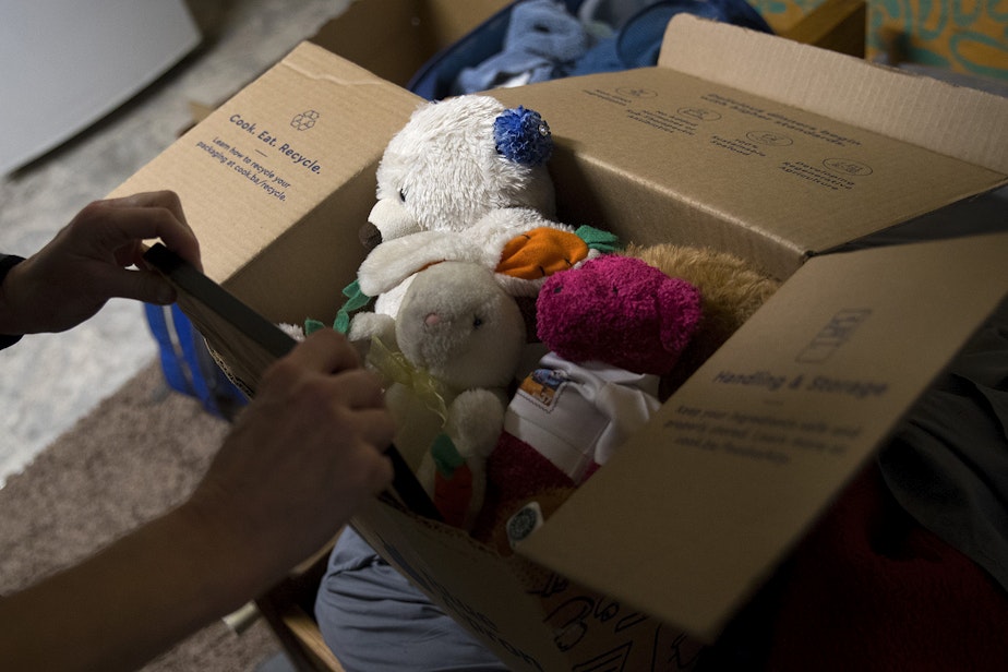 caption: Jerri Clark packs a box full of stuffed animals, including a rabbit that her son Calvin kept with him while he was experiencing homelessness, on Friday, March 22, 2019, at his apartment in Seattle.