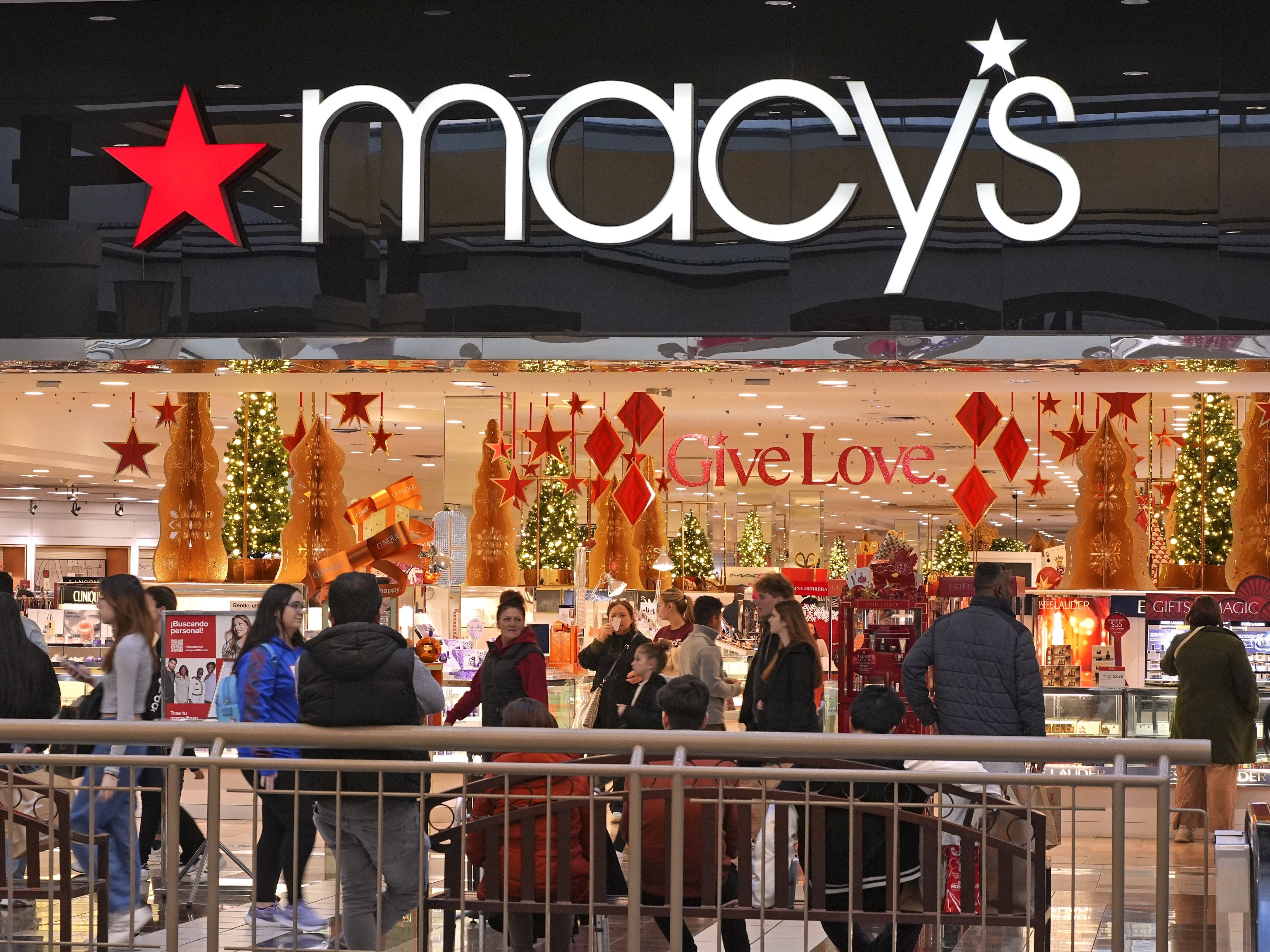 caption: Black Friday shoppers pass by at the Walden Galleria's Macy's in Buffalo, NY., on Friday.