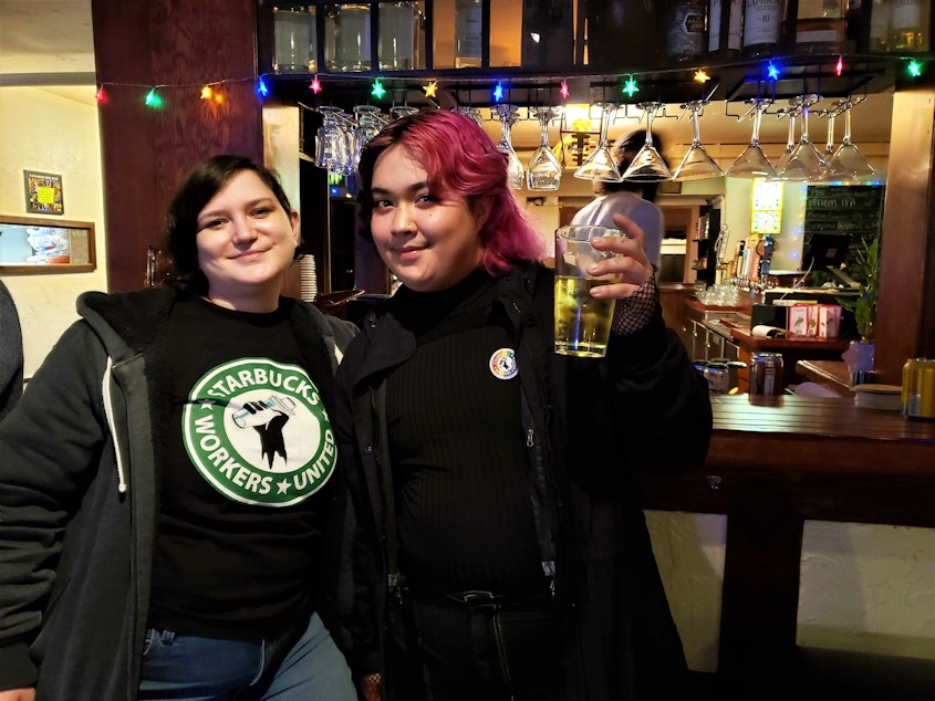caption: Starbucks shift manager Sarah Pappin and barista Phoenix Vinup at a union solidarity happy hour in March, 2022