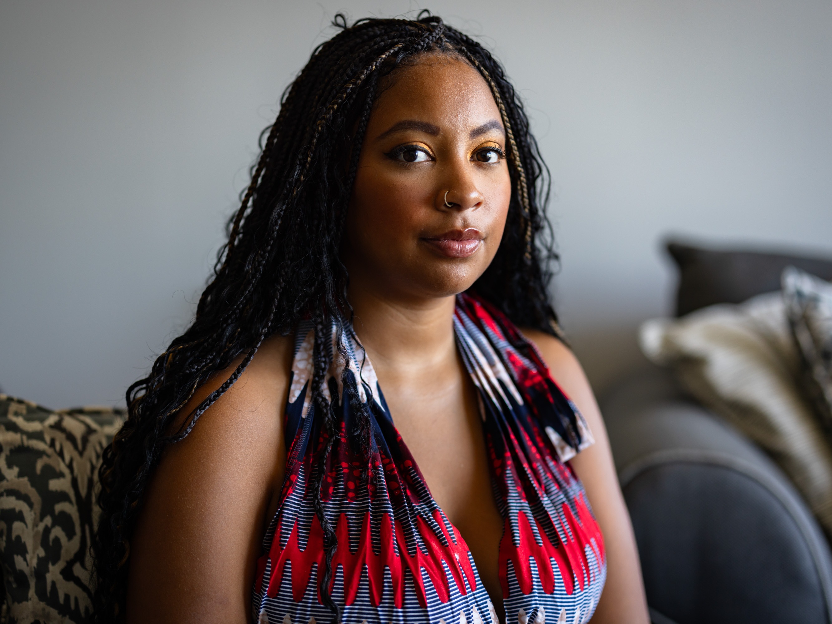 caption: Chenedy Wiles, 27, poses for a portrait at her home on Wednesday in Chicago. Wiles took a 23andMe test over the summer and got her results in September. While she finds the data breach concerning, “so much of our data is already out there,” she said.