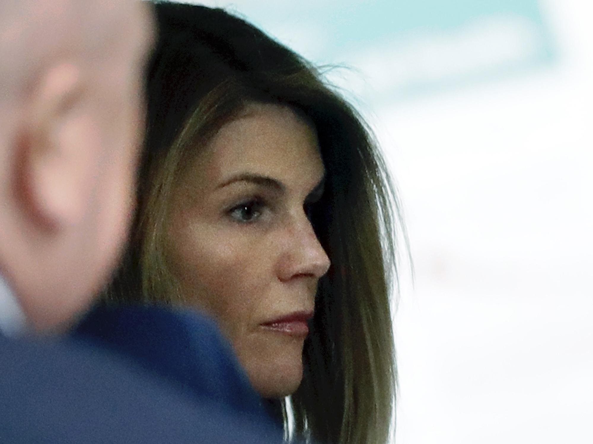 caption: Actress Lori Loughlin enters a federal court hearing about the scheme in Boston in August 2019.
