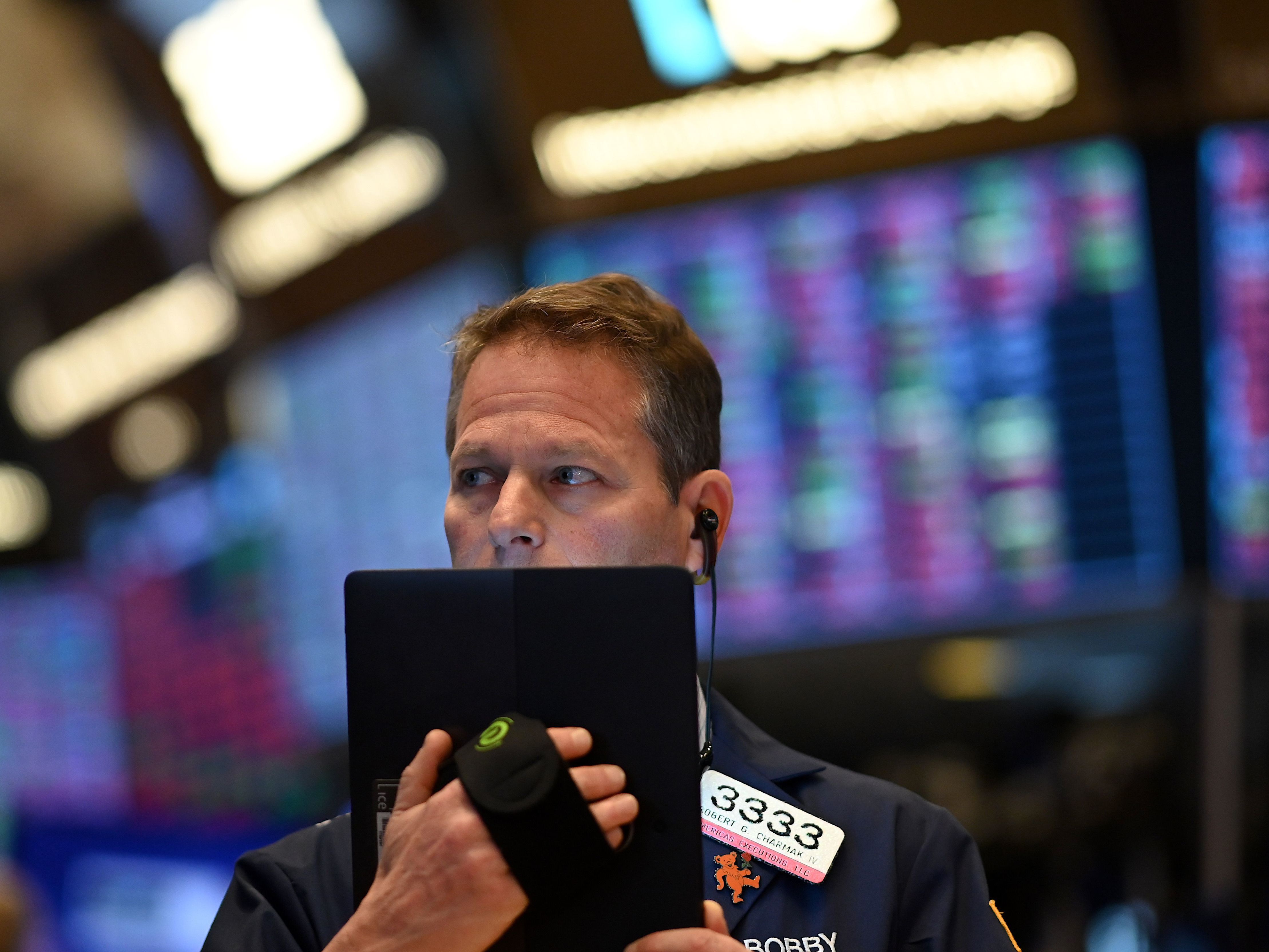 caption: Traders work during the opening bell at the New York Stock Exchange on Thursday. Wall Street stocks opened sharply lower amid fears the coronavirus will grow into a significant international health crisis.