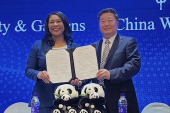 caption: San Francisco Mayor London Breed (left) and Wu Minglu, secretary general of the China Wildlife Conservation Association, hold up an agreement to lease giant pandas for the San Francisco Zoological Society and Gardens during a signing ceremony in Beijing on Friday.