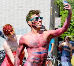 caption: For Tableau, a software company in Seattle's Fremont neighborhood, the bohemian neighborhood is part of the recruiting spiel. The Fremont Solstice Parade, above, embodies the spirit of the neighborhood.