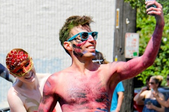 caption: For Tableau, a software company in Seattle's Fremont neighborhood, the bohemian neighborhood is part of the recruiting spiel. The Fremont Solstice Parade, above, embodies the spirit of the neighborhood.