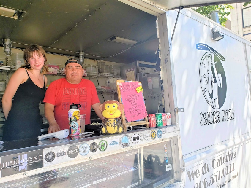 caption: Eleanor Henson (left) and Oscar Guerrero of Oskar's Pizza, one of the food trucks that cycle through Westlake Park, on Monday, August 22, 2022.