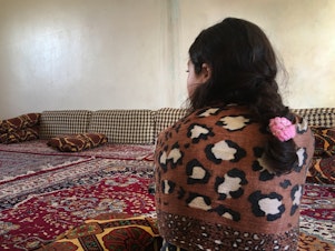 caption: Jeelan, 11, the day after being rescued from an ISIS family that had held her captive for the past two years. She says she doesn't remember her Yazidi family. "I want to go back to Um Ali," she says, referring to the Iraqi woman who had been pretending to be her mother in a detention camp for ISIS families. "Um Ali is my real family."