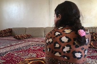 caption: Jeelan, 11, the day after being rescued from an ISIS family that had held her captive for the past two years. She says she doesn't remember her Yazidi family. "I want to go back to Um Ali," she says, referring to the Iraqi woman who had been pretending to be her mother in a detention camp for ISIS families. "Um Ali is my real family."