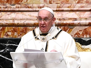 caption: Pope Francis is seen giving a homily on Christmas Eve. Francis on Sunday condemned the violence at the U.S. Capitol and prayed for reconciliation.