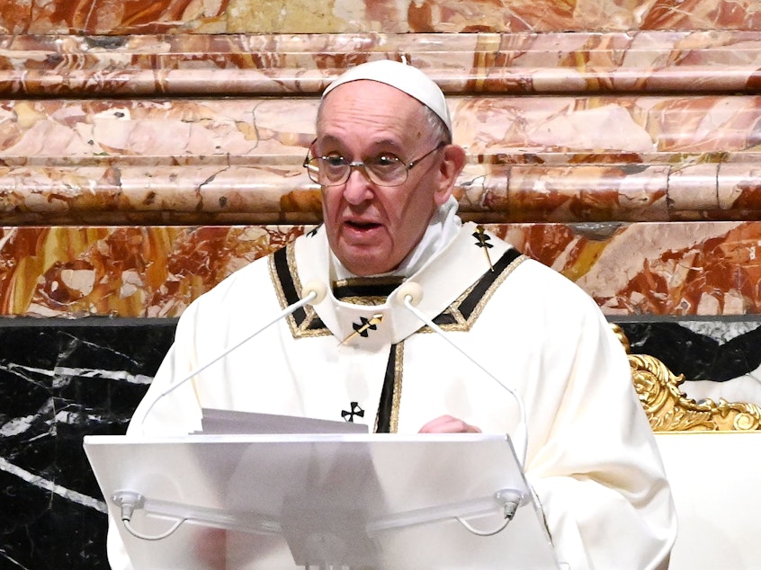 caption: Pope Francis is seen giving a homily on Christmas Eve. Francis on Sunday condemned the violence at the U.S. Capitol and prayed for reconciliation.