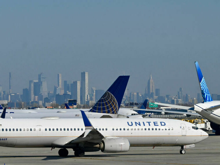 caption: United Air Lines planes line up along the busy Newark Liberty International Airport, New Jersey, on the eve of Thanksgiving on November 23, 2022.