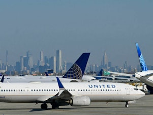 caption: United Air Lines planes line up along the busy Newark Liberty International Airport, New Jersey, on the eve of Thanksgiving on November 23, 2022.