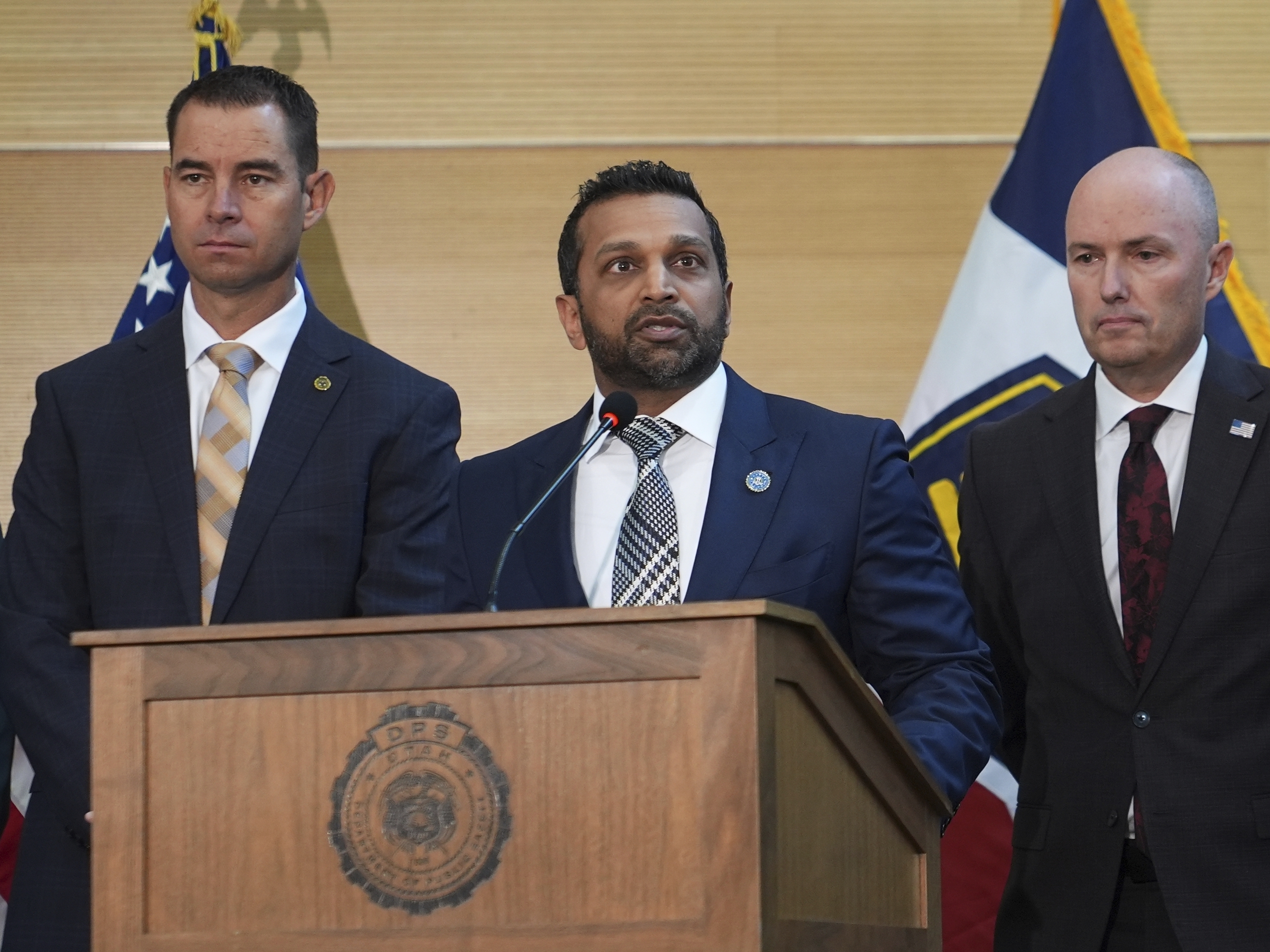 caption: FBI Director Kash Patel speaks at a news conference on Sept. 12, 2025, in Orem, Utah, as Utah department of public safety commissioner Beau Mason, left, and Utah Gov. Spencer Cox listen. (AP Photo/Lindsay Wasson)
