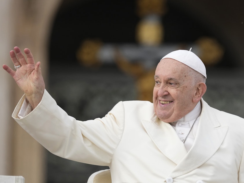 caption: Pope Francis waves to the  faithful at the end of his weekly general audience in St. Peter's Square at the Vatican on Wednesday, Nov. 22, 2023. The pope, who will turn 87 next month, canceled his trip to Dubai for the U.N. climate conference on doctors' orders.