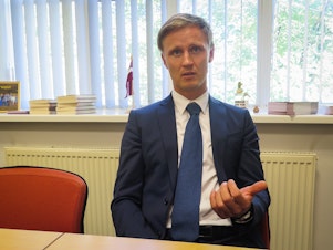 caption: Rihards Kols is a nationalist member of Latvia's parliament who believes his country must protect its language from Russian influence.