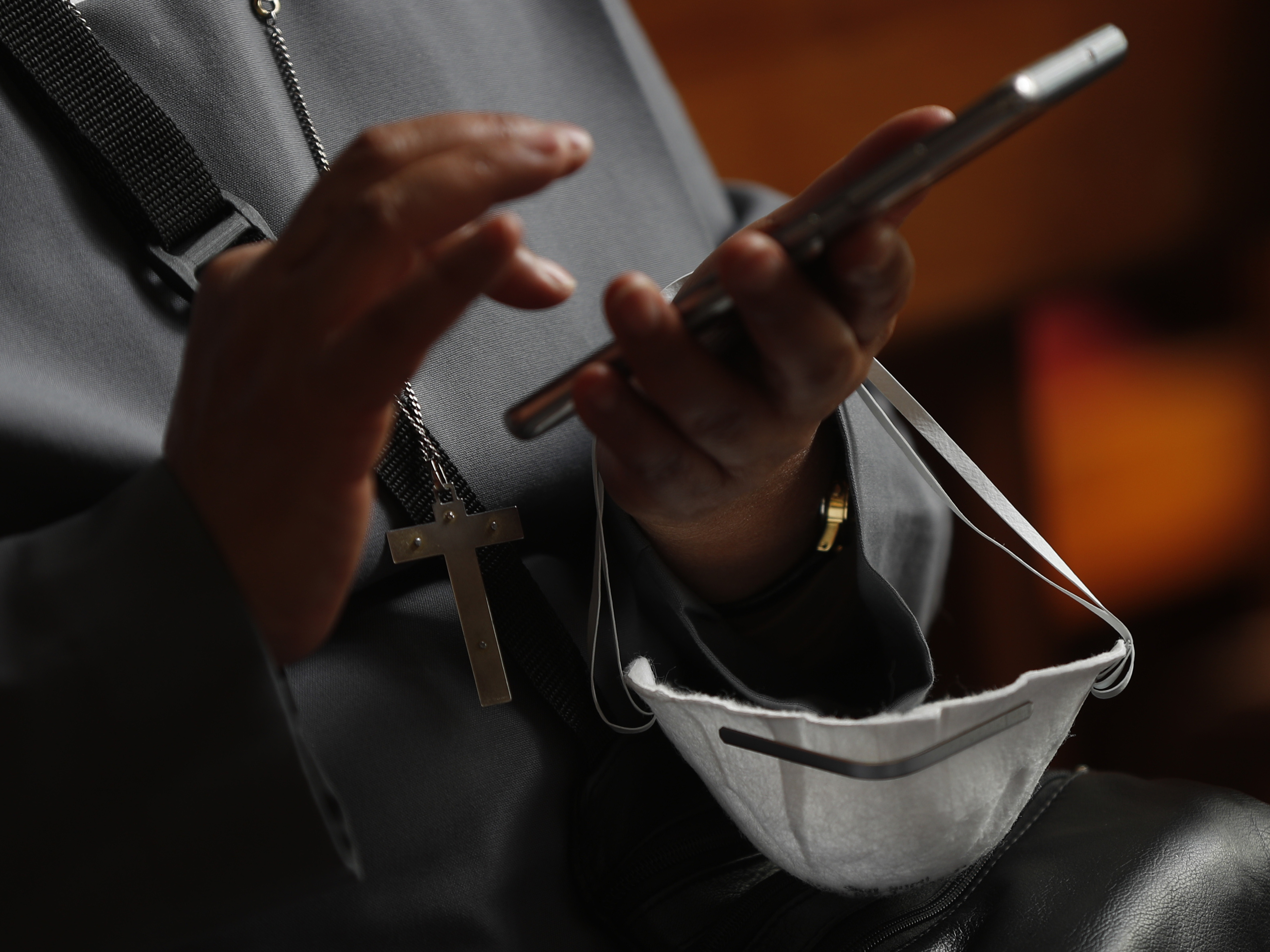 caption: "Together, let's reject the lies and nonsense out there," U.N. Secretary-General António Guterres said Tuesday, referring to rampant misinformation about the COVID-19 pandemic. Here, a nun holds her phone and a protective face mask in La Paz, Bolivia.