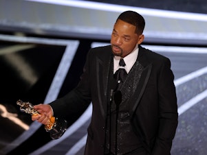 caption: Will Smith accepts the Oscar for best actor in a leading role on Sunday night.
