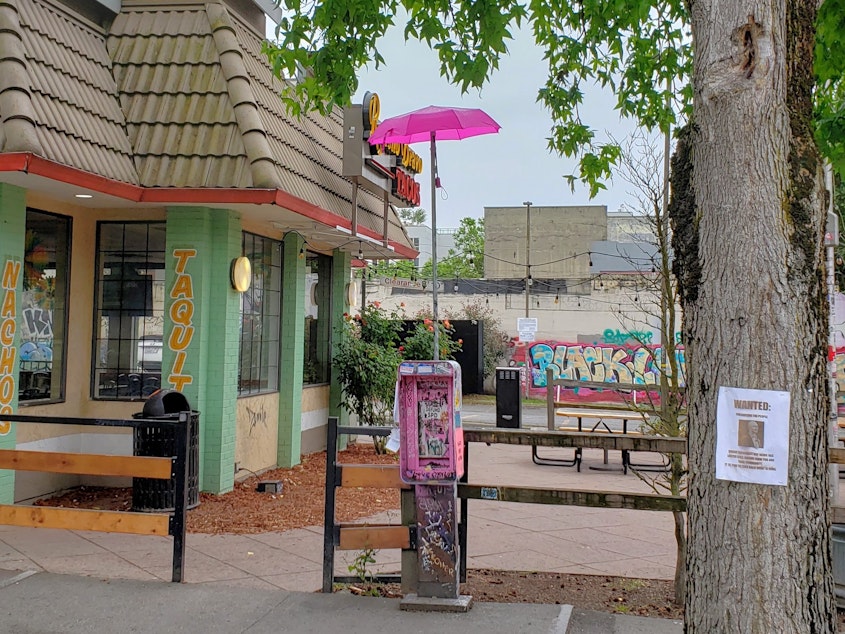 caption: "I'll leave you with a photo of a lone pink umbrella in the middle of an empty #CHOP. (No, it's not *that* umbrella)." KUOW's Casey Martin reporting from the Capitol Hill Occupied Protest zone on July 1st 2020, shortly after the city cleared out the largely peaceful protest.