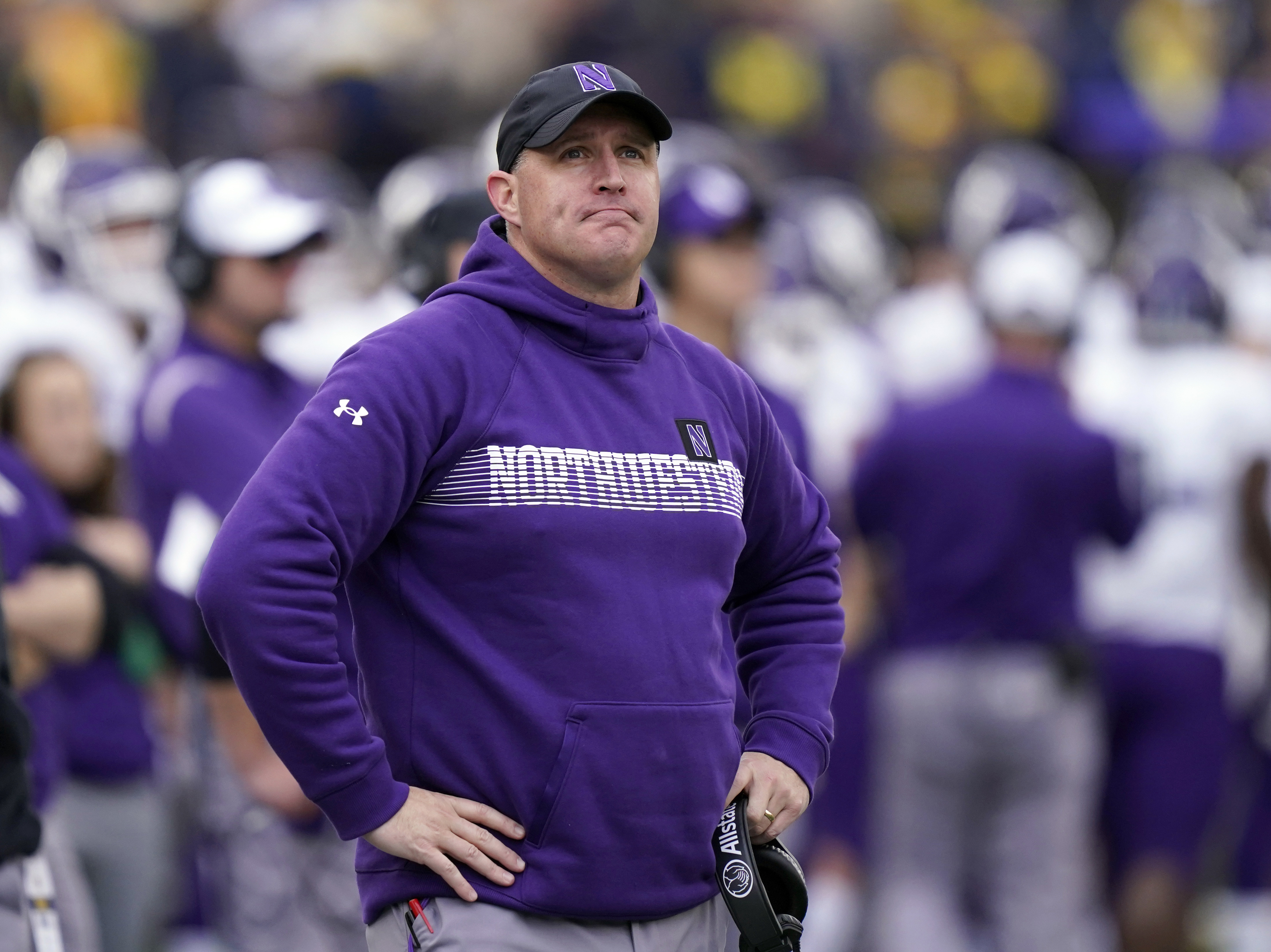 caption: Then-Northwestern head coach Pat Fitzgerald stands on the sideline during a game against Michigan on Oct. 23, 2021, in Ann Arbor, Mich.