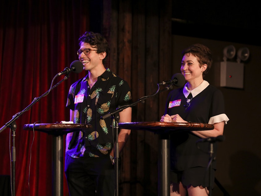 caption: Contestants compete in Ask Me Another's final round at the Bell House in Brooklyn, New York.