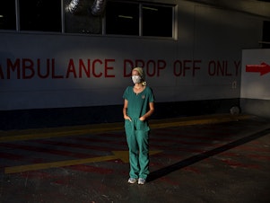 caption: Emergency medical medical officer Dr. Storm Bissict, 35, photographed outside the ER entrance of Netcare Christiaan Barnard Memorial Hospital, Cape Town, South Africa, on the morning of January 19. To escape the stresses of her job during a pandemic, she dives into the ocean.