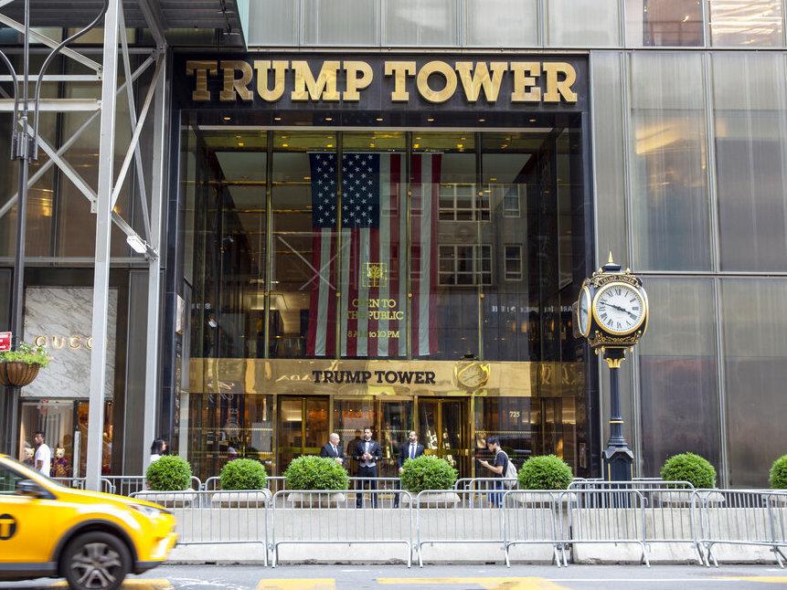 caption: A taxi passes by Trump Tower, the headquarters of the Trump Organization, in New York City in 2021.