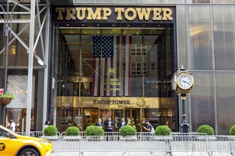 caption: A taxi passes by Trump Tower, the headquarters of the Trump Organization, in New York City in 2021.