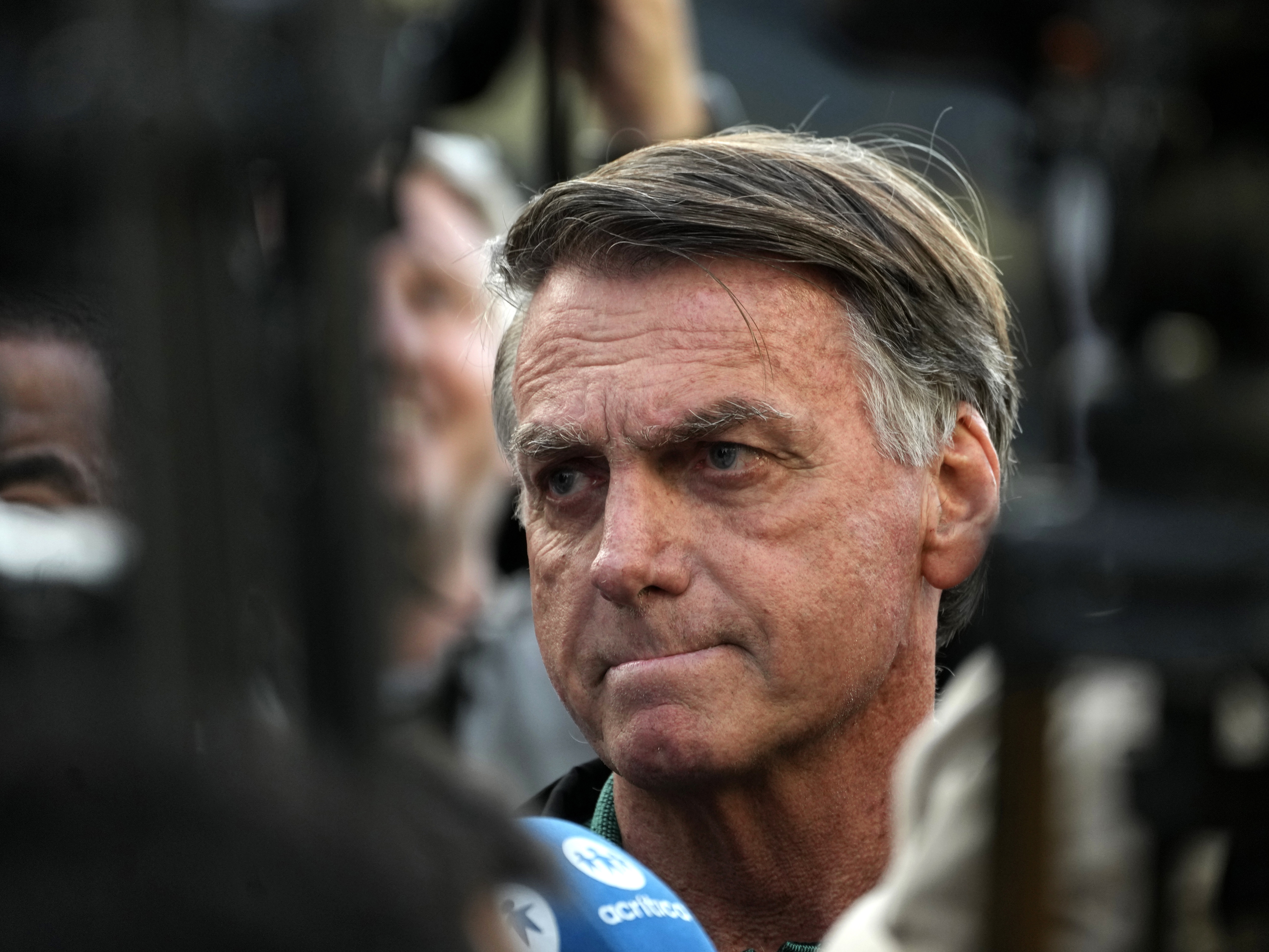 caption: Former President Jair Bolsonaro speaks to the press after testifying to the federal police in an investigation involving his son, former Congressman Eduardo Bolsonaro, in Brasilia, Brazil, Thursday, June 5, 2025. (AP Photo/Eraldo Peres)