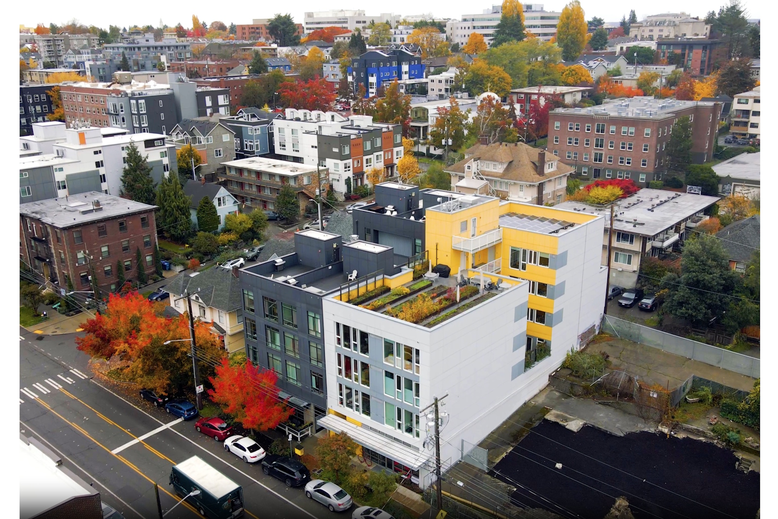 caption: Capitol Hill Urban Cohousing (the white and  yellow building on the right) as seen from the air.