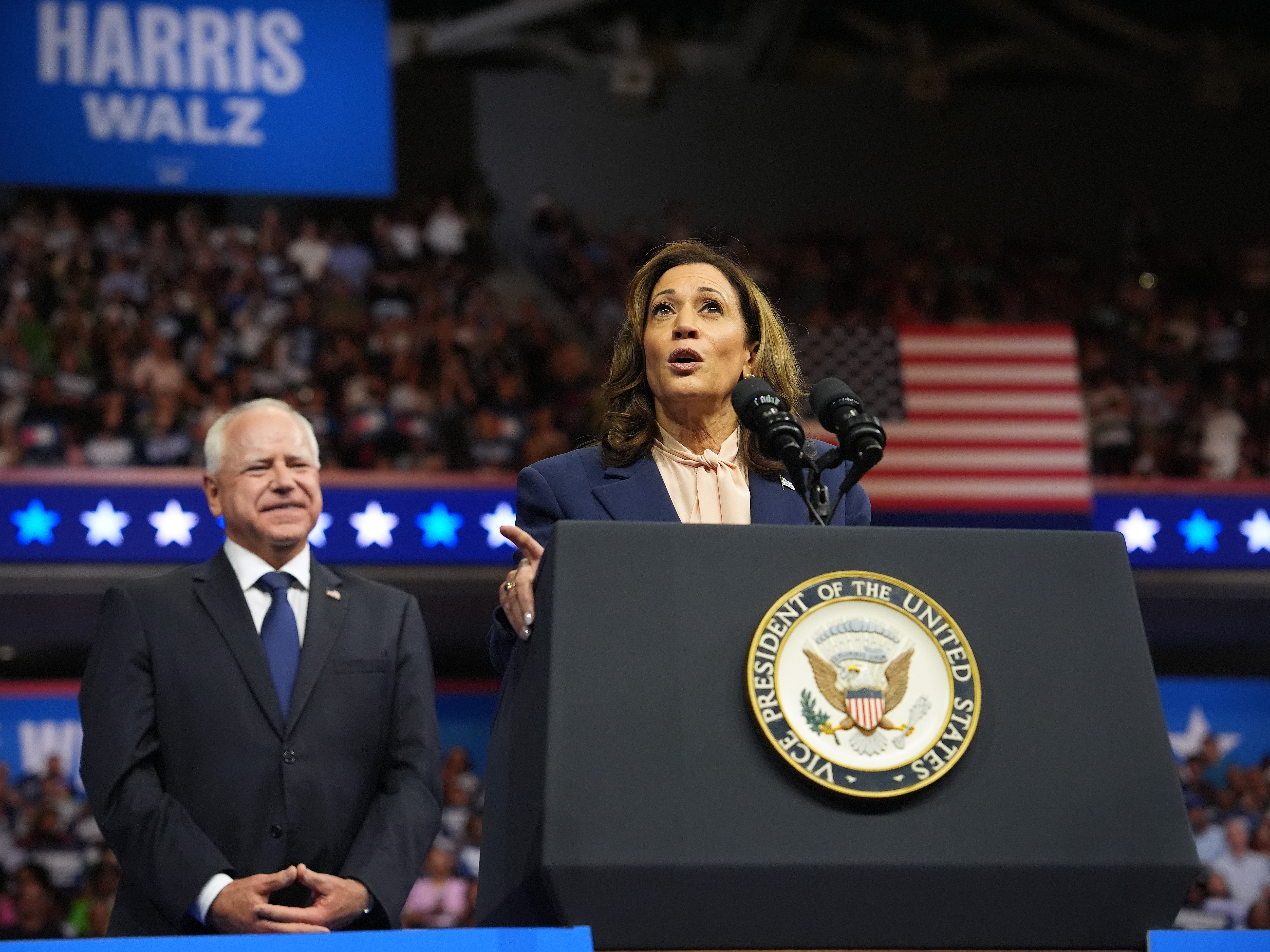 caption: Vice President Kamala Harris, the Democratic presidential nominee, speaks as her running mate Minnesota Gov. Tim Walz looks on during a campaign event in Philadelphia on August 6. 