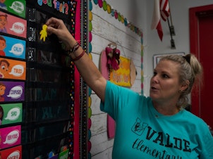 caption: Nicole Ogburn shows the new tool that she will use this year to know the emotional state of her students.