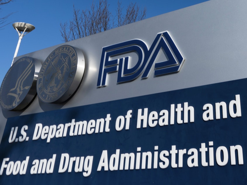 caption: A sign for the U.S. Food and Drug Administration is displayed outside its offices in Silver Spring, Md., on Dec. 10, 2020. The FDA says it's considering banning brominated vegetable oil, a food additive.