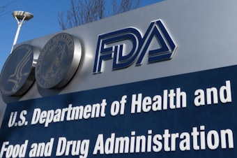 caption: A sign for the U.S. Food and Drug Administration is displayed outside its offices in Silver Spring, Md., on Dec. 10, 2020. The FDA says it's considering banning brominated vegetable oil, a food additive.