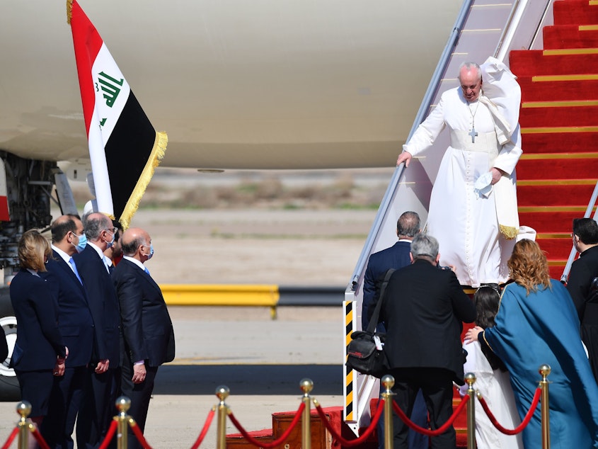caption: Pope Francis arrives at Baghdad International Airport on Friday for the first-ever papal visit to Iraq.