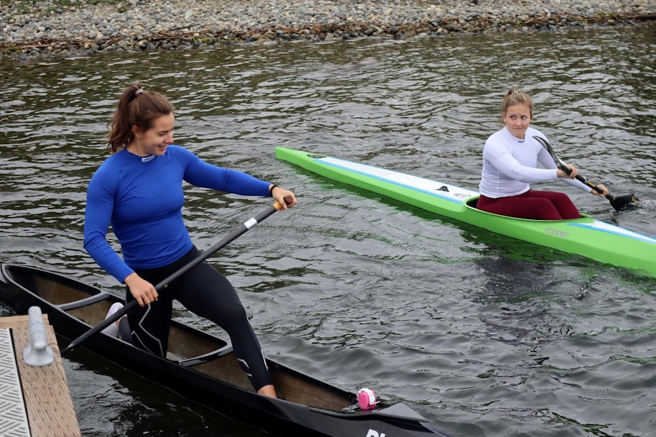 caption: Sprint canoeist Nevin Harrison, left, and kayak racer Anna McGrory head out for a workout in Seattle on May 21, 2021.