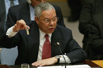 caption: Then-U.S. Secretary of State Colin Powell holds up a vial that he said was the size that could be used to hold anthrax as he addresses the United Nations Security Council in February 2003 at the U.N. in New York.