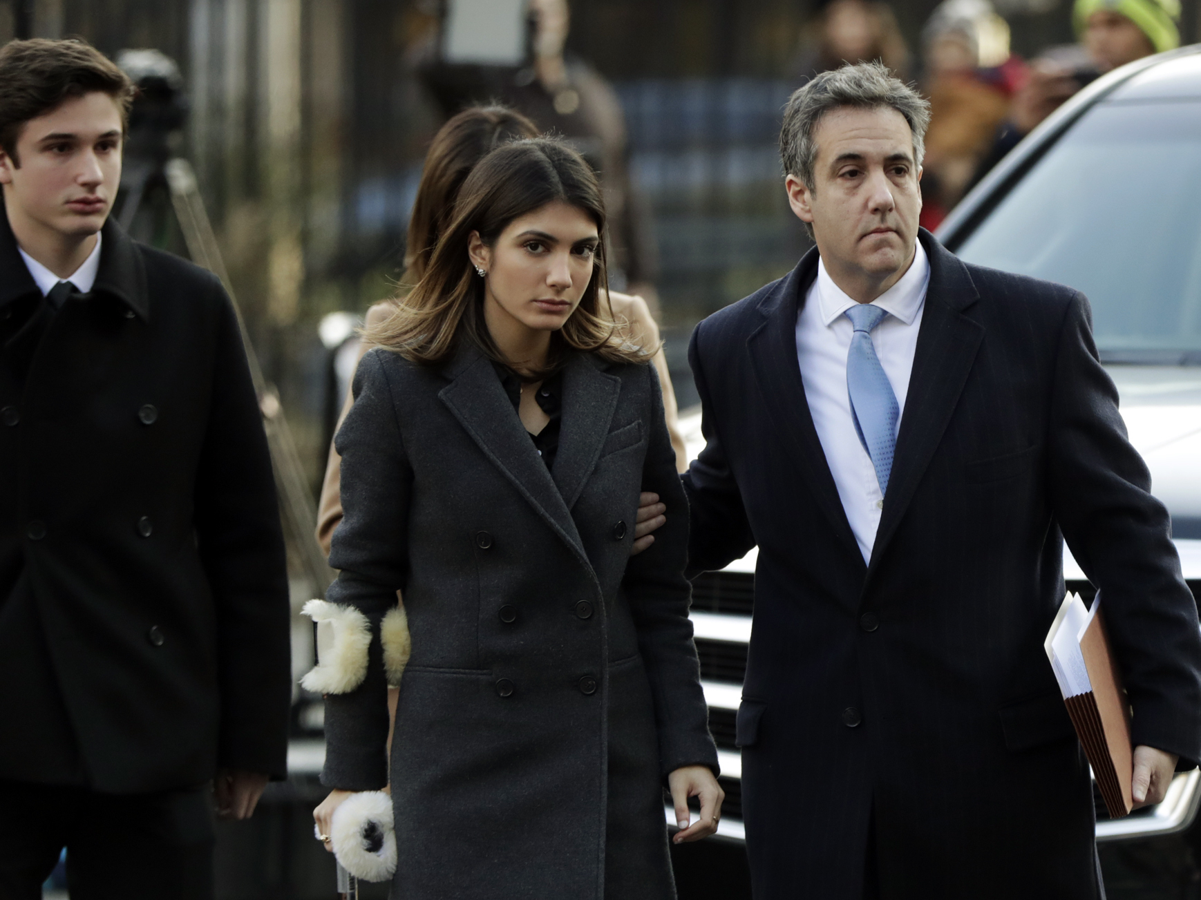 caption: Michael Cohen, (right) Donald Trump's former lawyer, arrives at federal court, with his children Jake and Samantha, for his sentencing in New York on Wednesday.