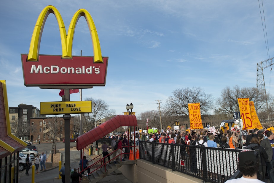 caption: Fast food workers strike and protest for a $15/hour minimum wage at a McDonald's restaurant in Minnesota.